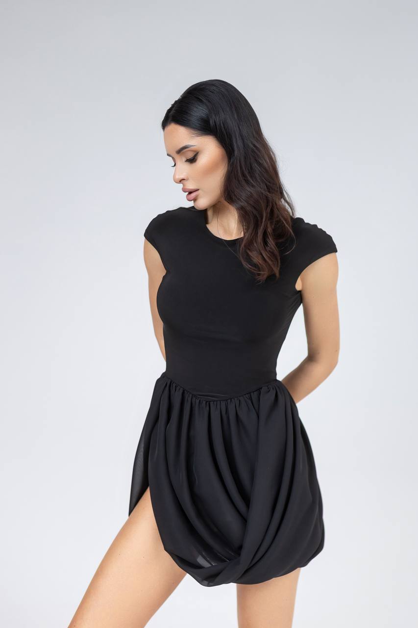 Woman wearing a black dress on a white background
