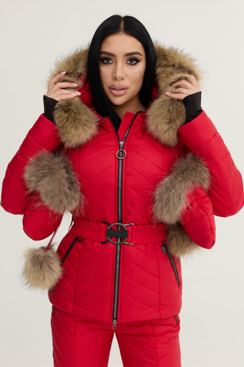 Person wearing a red puffer jacket with fur trim on a white background