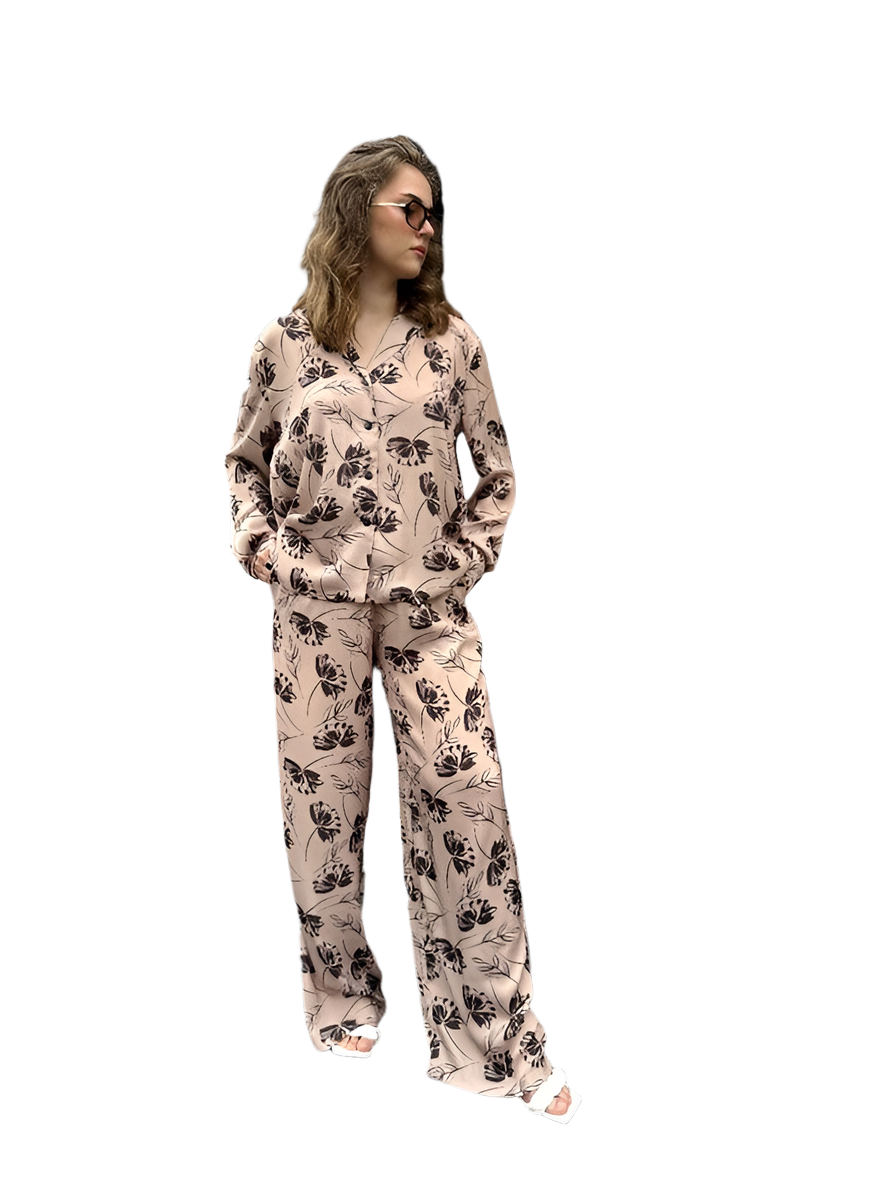 Woman wearing a floral pajama set on a white background