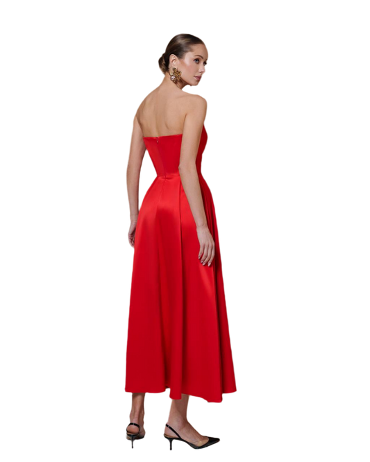 Woman wearing a red strapless gown on a white background