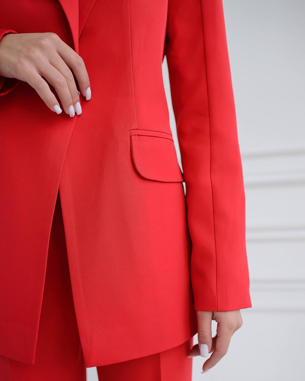 Red suit jacket worn by a person on a light gray background