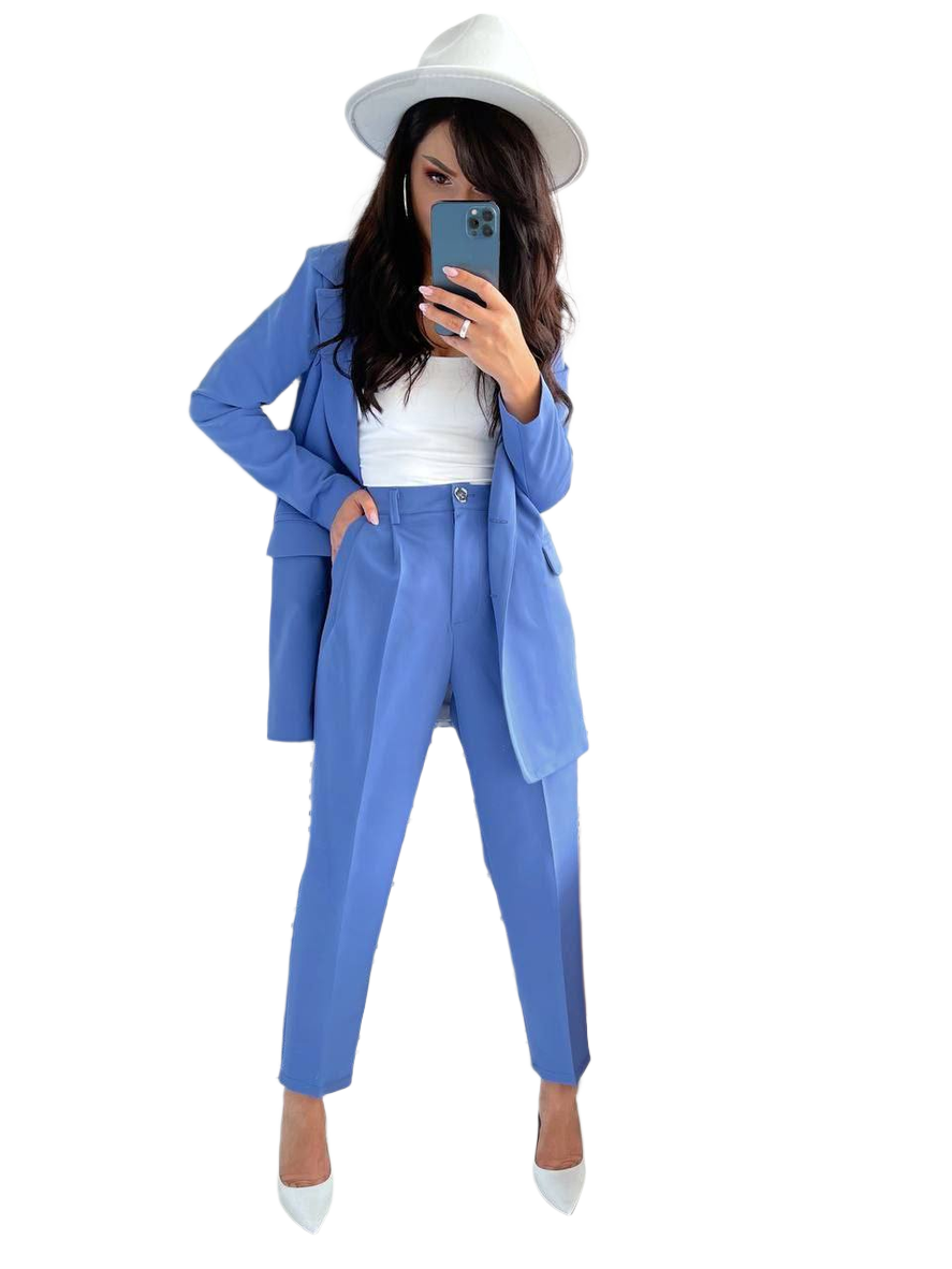 Person wearing a blue suit and white hat taking a mirror selfie.