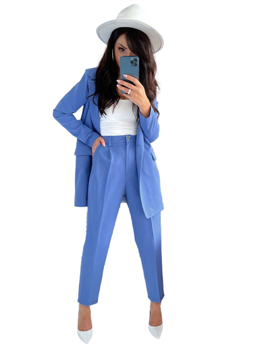 Person wearing a blue suit and white hat taking a mirror selfie.