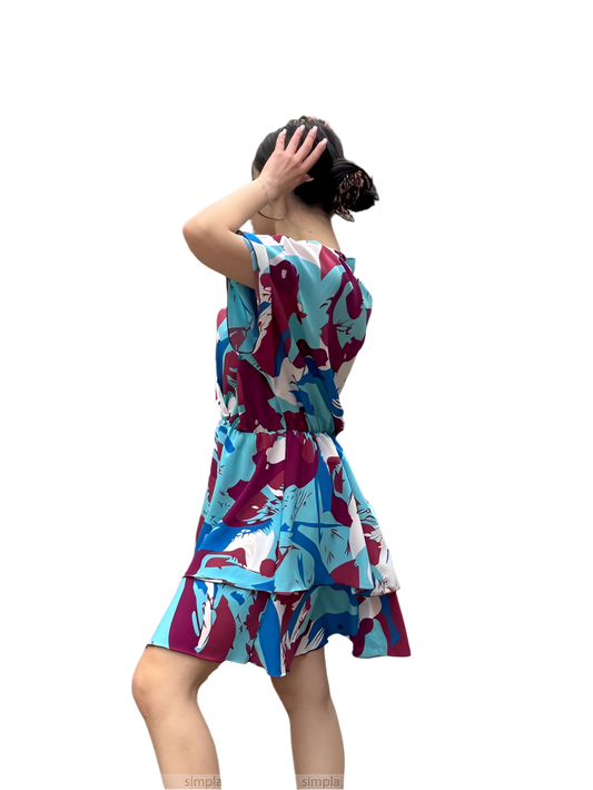 Woman wearing a colorful dress with abstract patterns on a white background