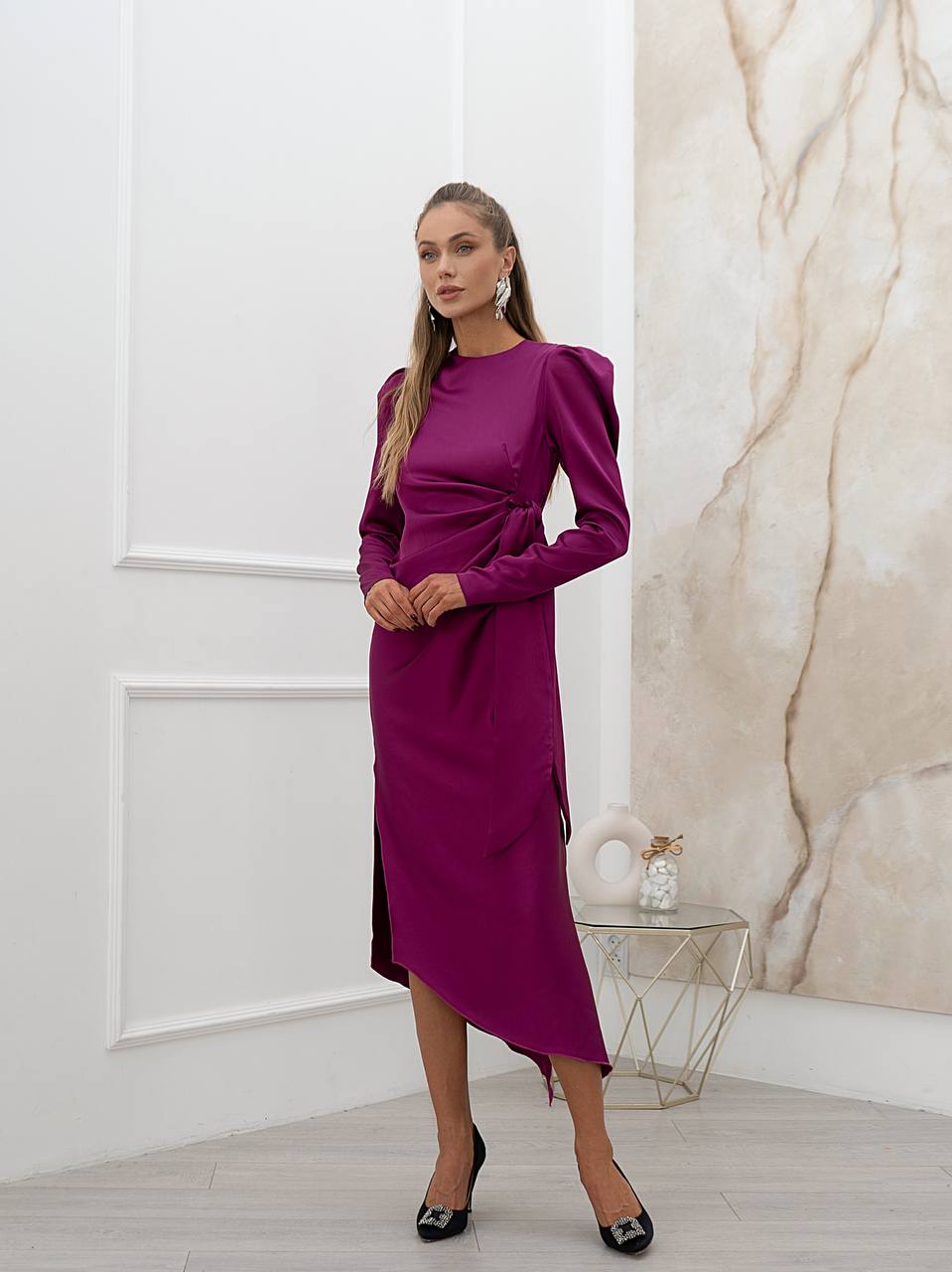 Woman wearing a magenta dress in an elegant interior setting