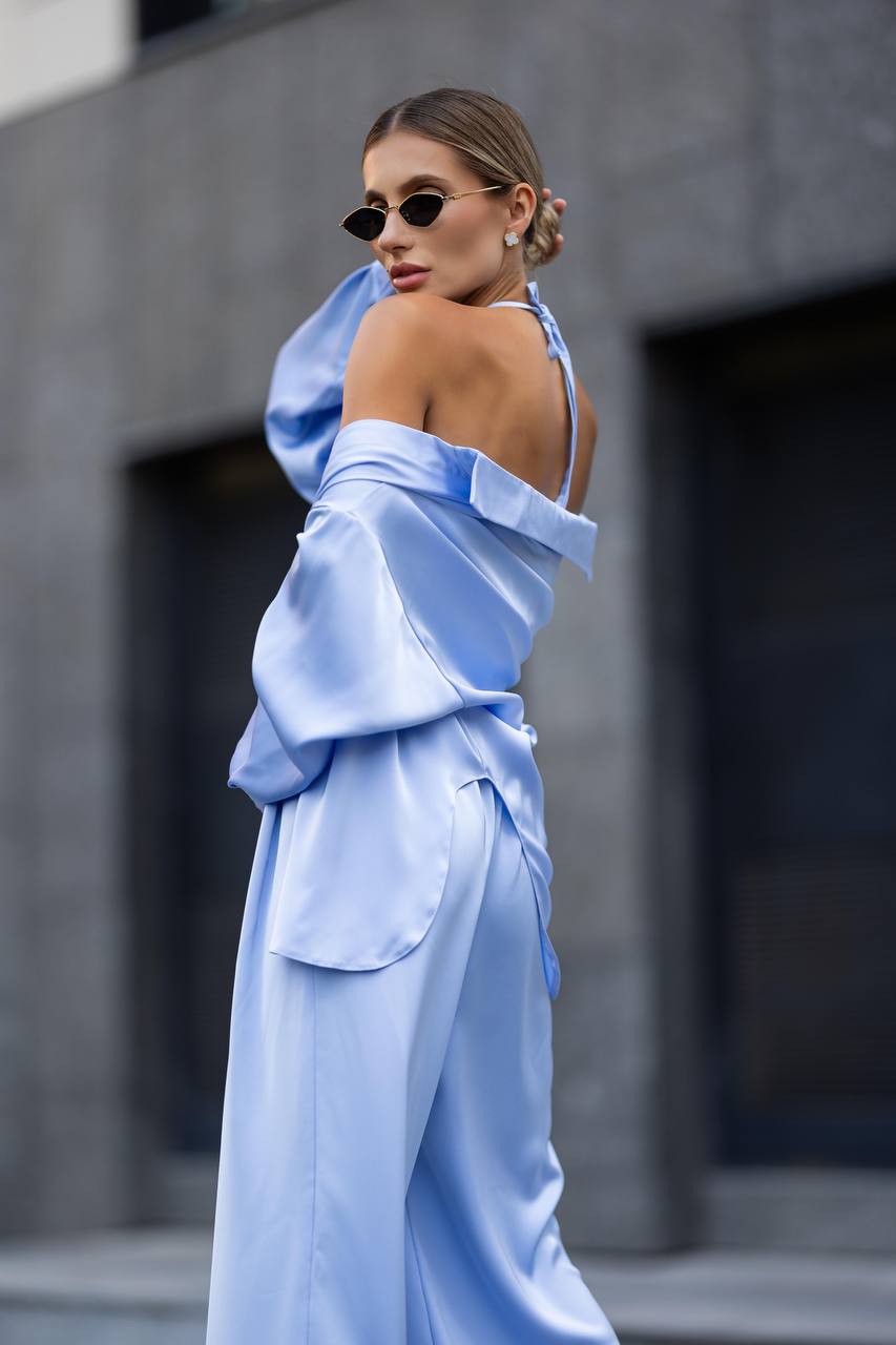 Woman wearing a light blue outfit with a blurred background