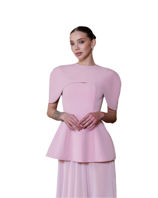 Woman wearing a pink dress with a plain background