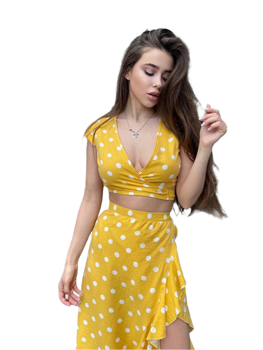 Woman wearing a yellow polka dot dress on a white background