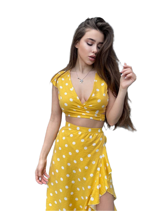 Woman wearing a yellow polka dot dress on a white background