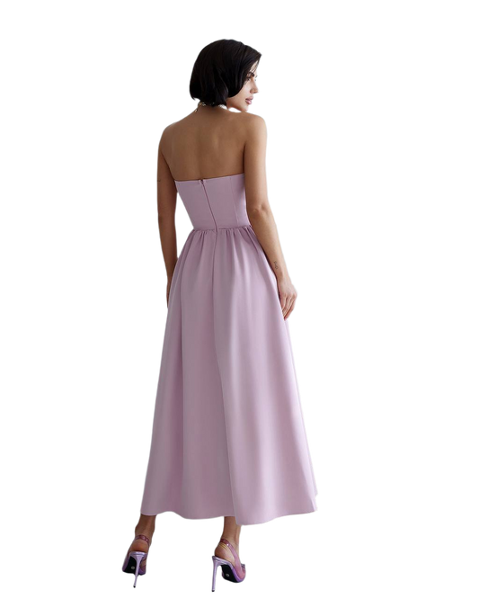 Woman wearing a strapless pink gown on a white background