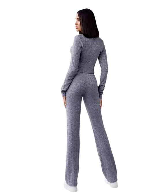 Woman wearing a gray knit outfit on a white background