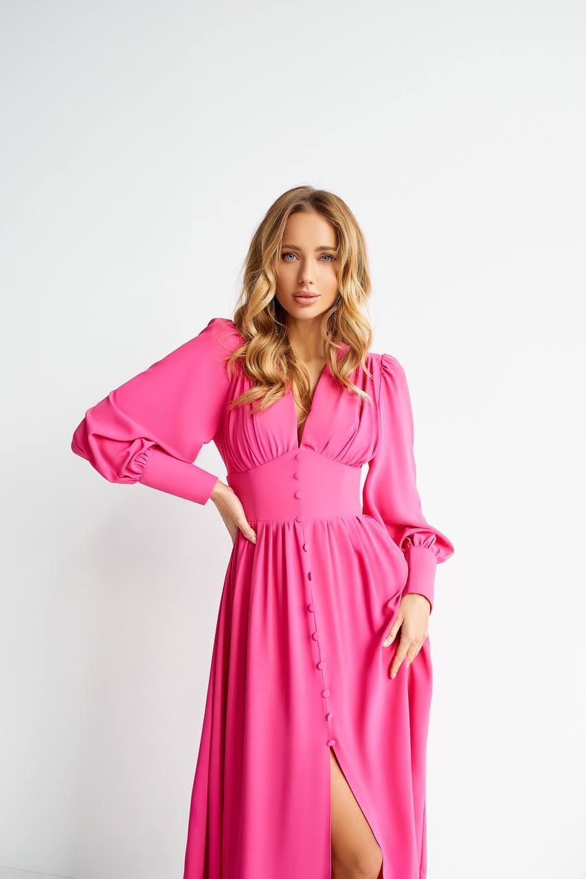 Woman wearing a pink dress with a white background