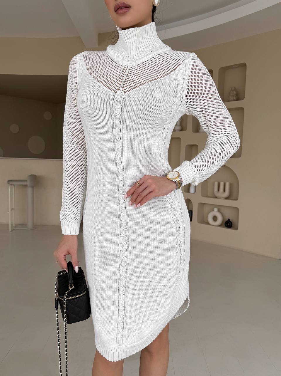 White knit dress worn by a person in an indoor setting