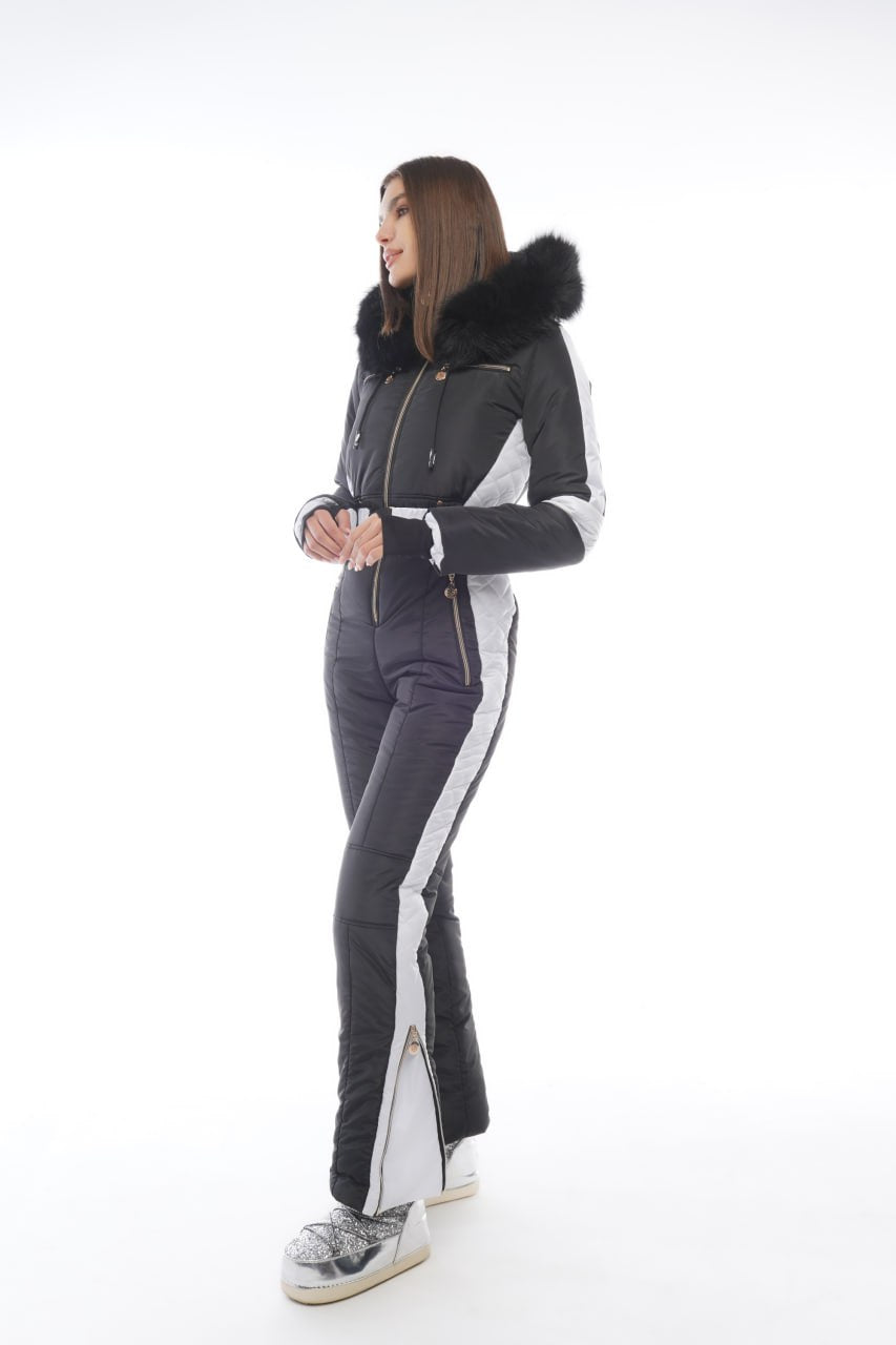 Person wearing a gray and white ski suit with a fur-lined hood on a white background