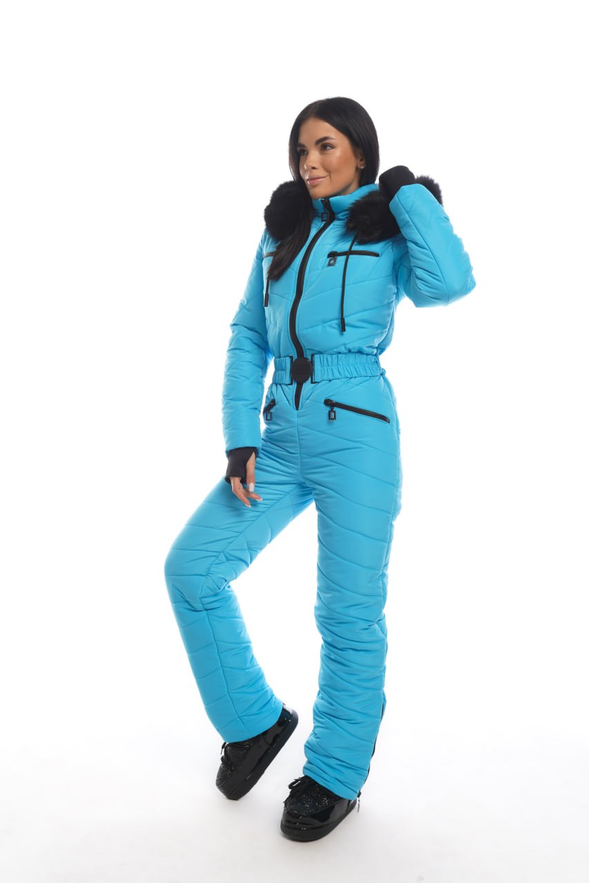 Person wearing a blue ski suit with black fur trim on a white background