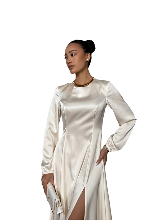 Woman wearing a white satin dress with long sleeves on a white background