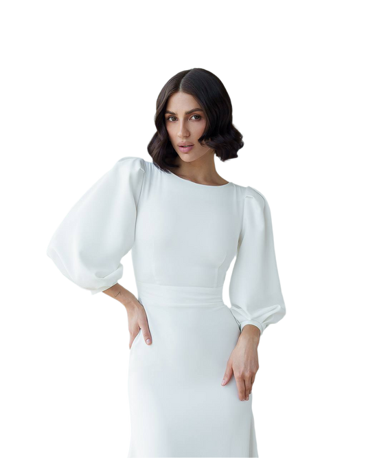 Woman wearing a white dress with puffed sleeves on a white background
