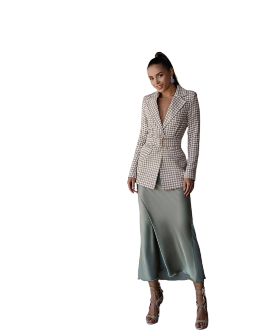 Woman wearing a checkered blazer and green skirt on a white background