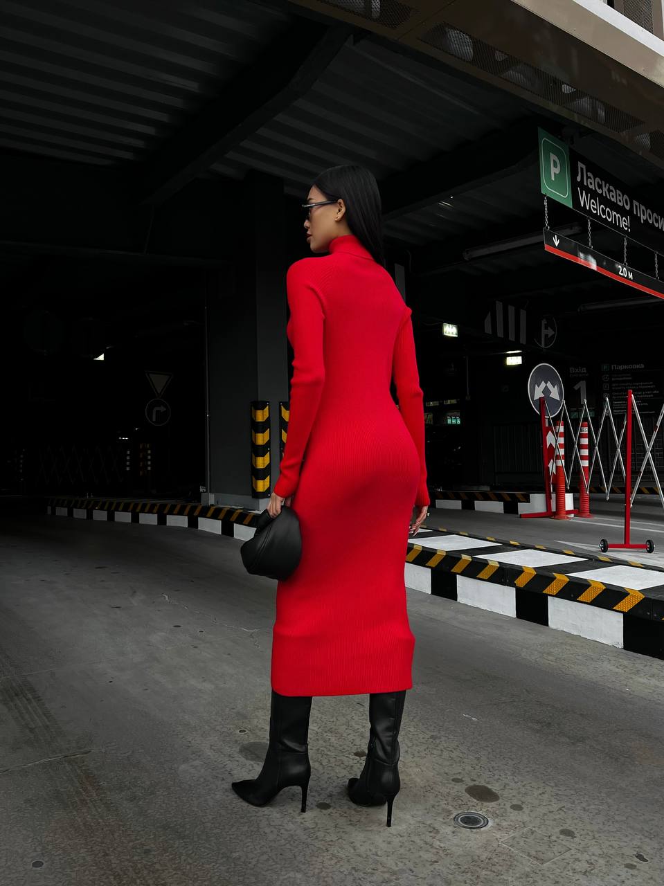 Person wearing a red coat walking in an urban setting
