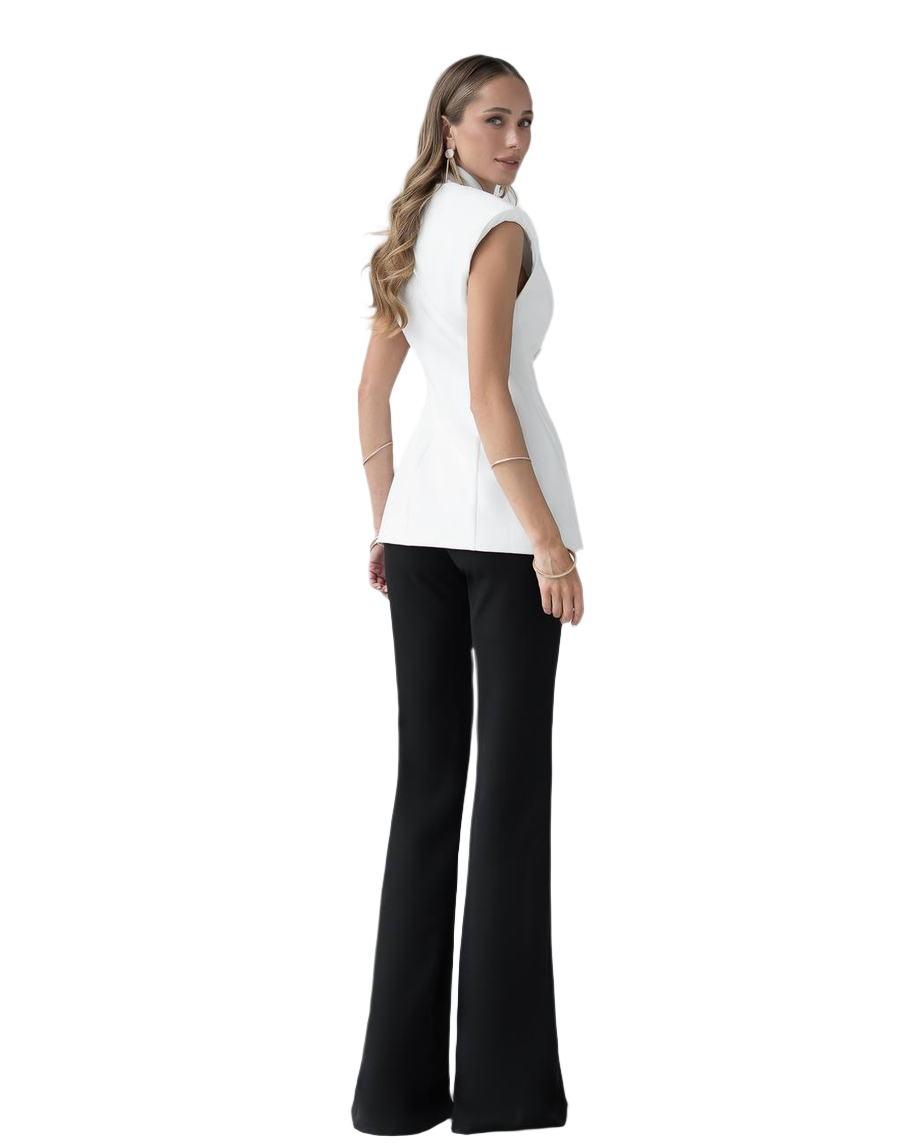 Woman wearing a white sleeveless top and black pants on a white background