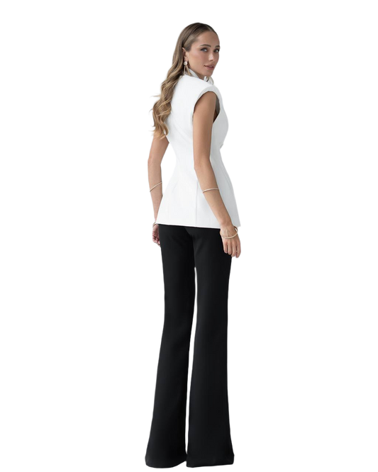 Woman wearing a white sleeveless top and black pants on a white background