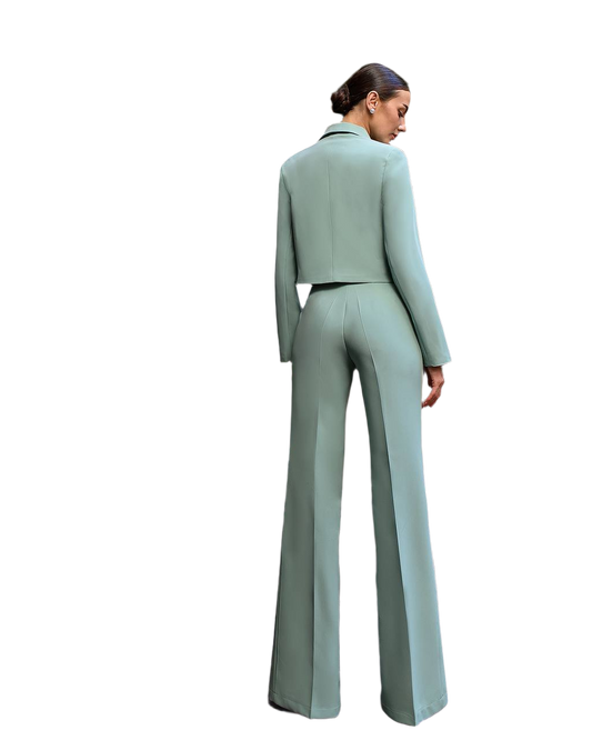 Woman wearing a light green suit on a white background