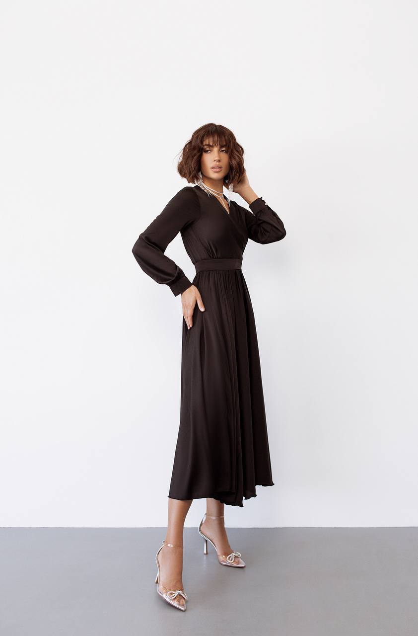 Woman wearing a black dress against a white background