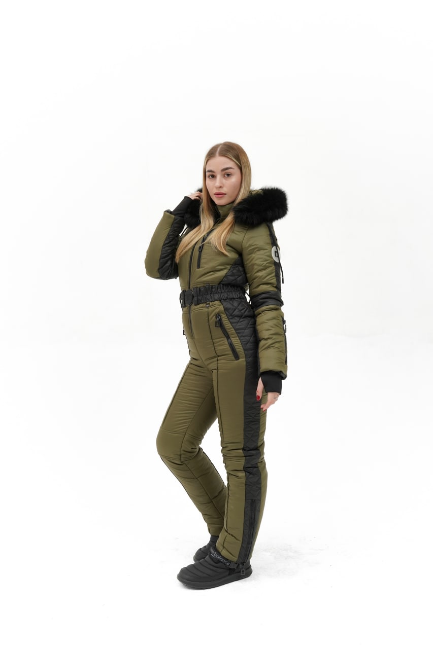 Woman wearing a green and black winter outfit on a white background