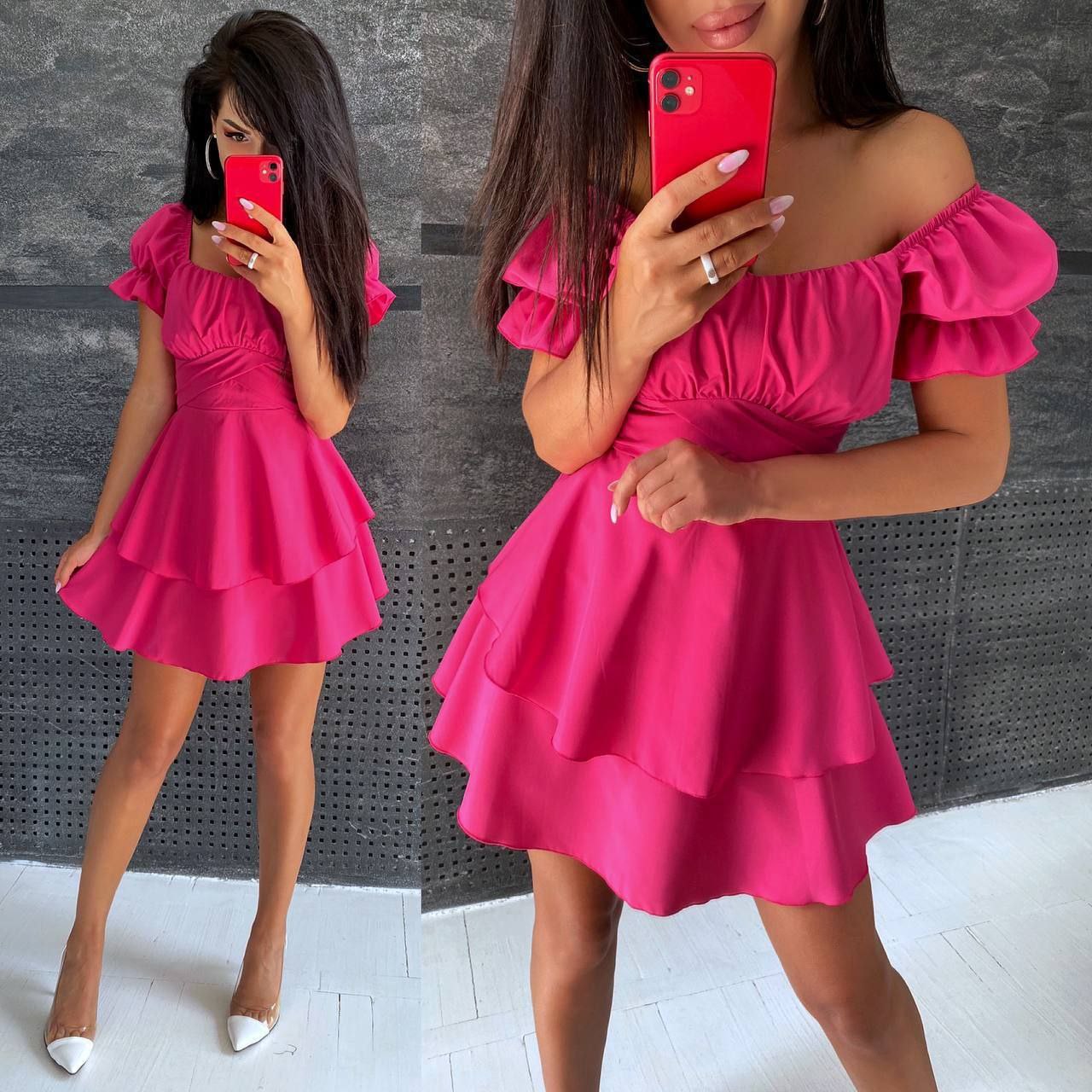 Woman wearing a pink off-shoulder dress taking a mirror selfie.