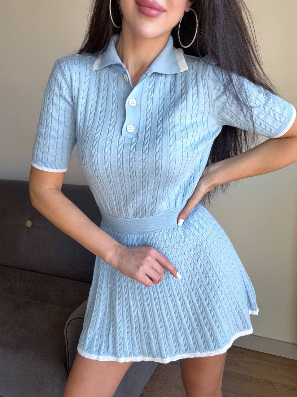 Light blue textured dress worn by a person indoors.