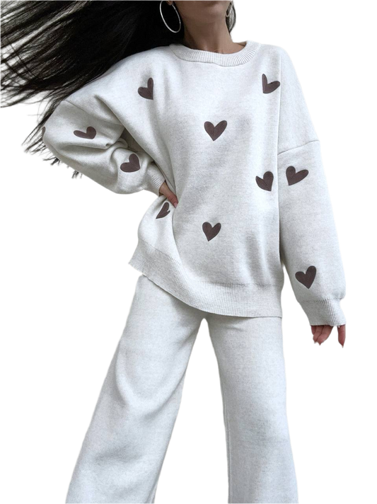 White outfit with heart patterns on a plain background
