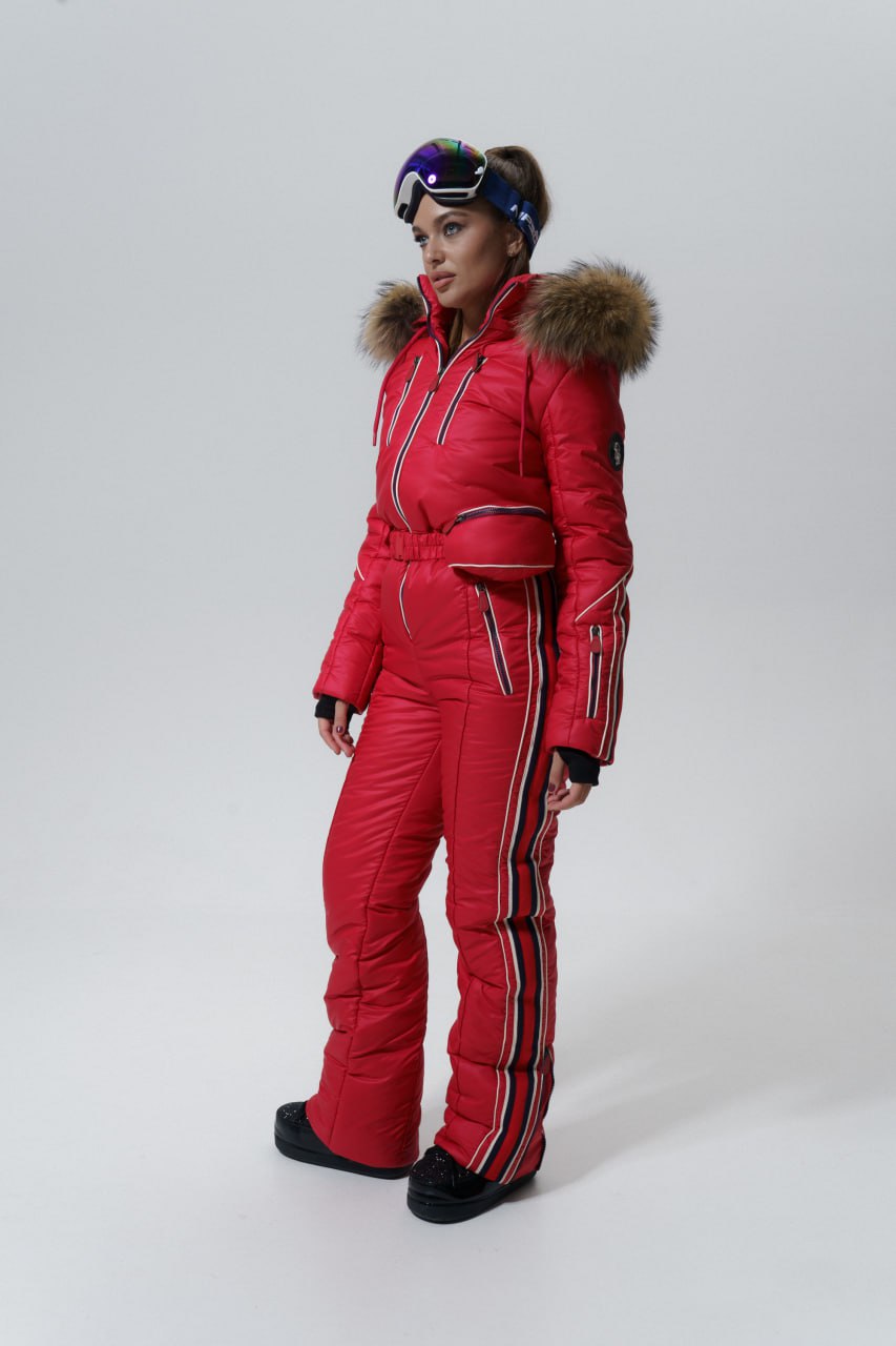 Person wearing a red ski suit with fur hood on a white background