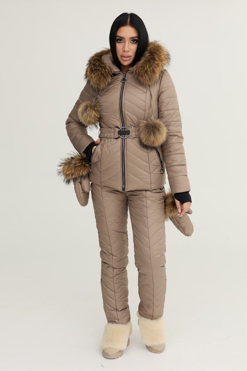 Person wearing a beige puffer suit with fur trim on a white background