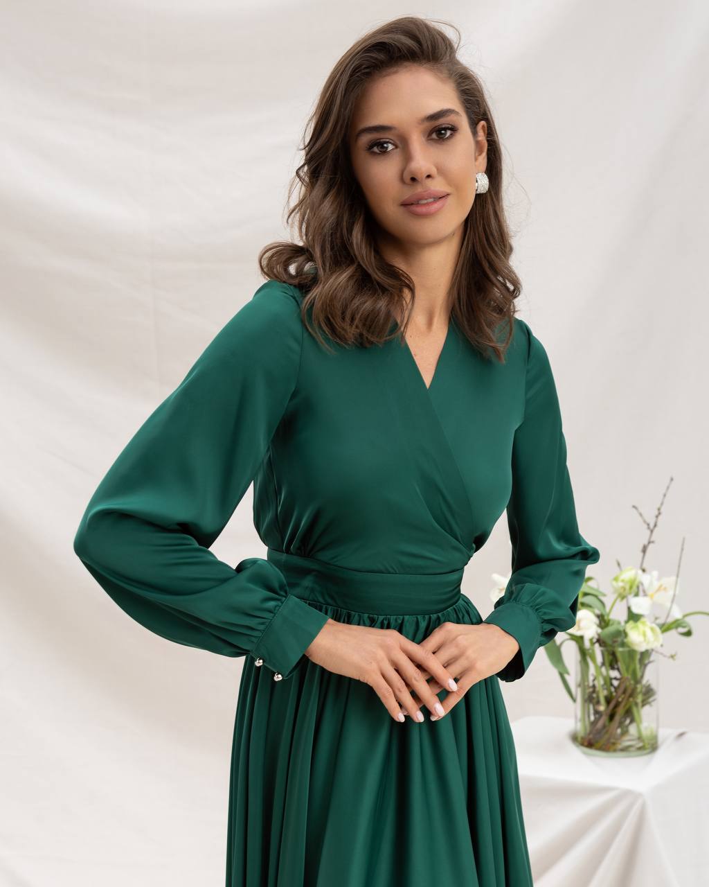 Woman wearing a green dress against a white background