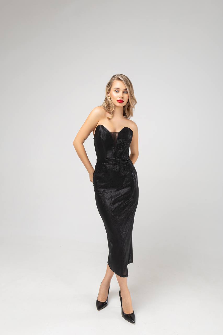 Woman wearing a black strapless dress on a white background