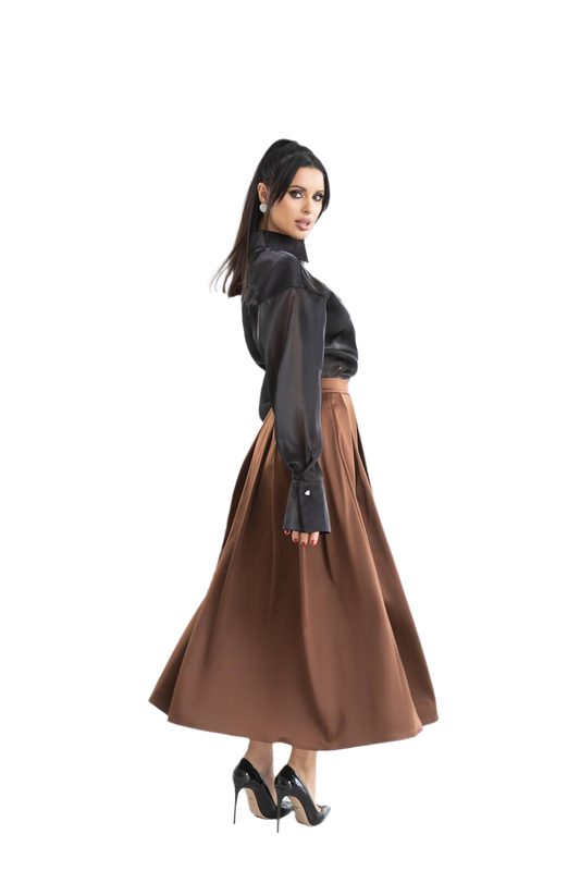 Woman wearing a black blouse and brown skirt on a white background