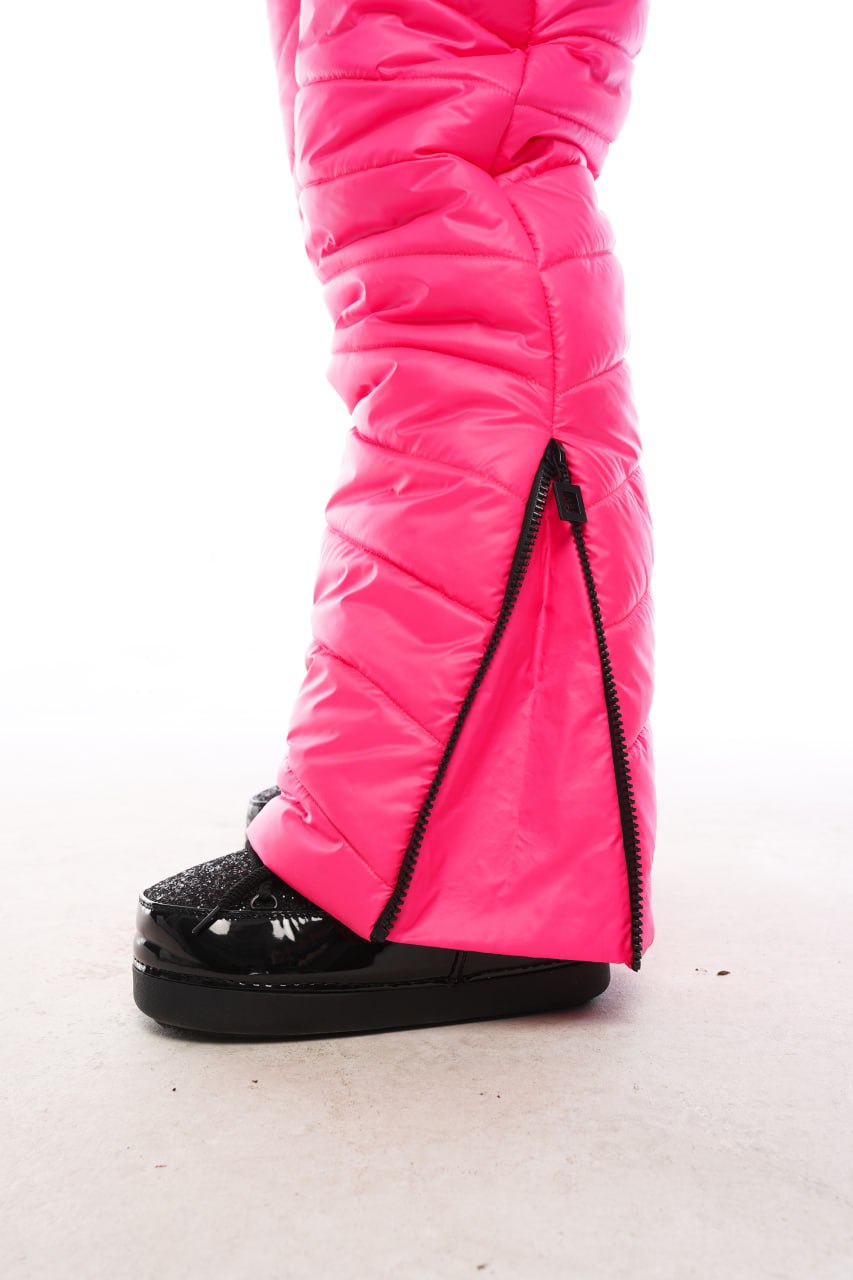 Bright pink ski boot covers with a black sole on a white background