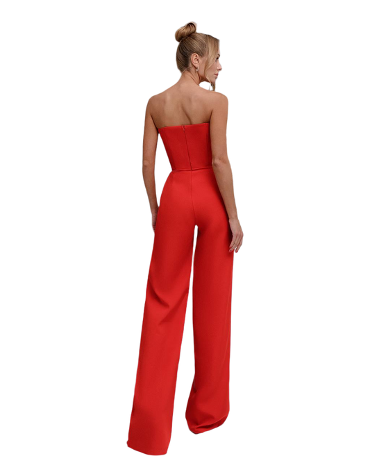 Red strapless jumpsuit worn by a model on a white background