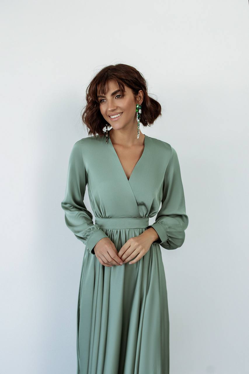 Woman wearing a green dress against a white background