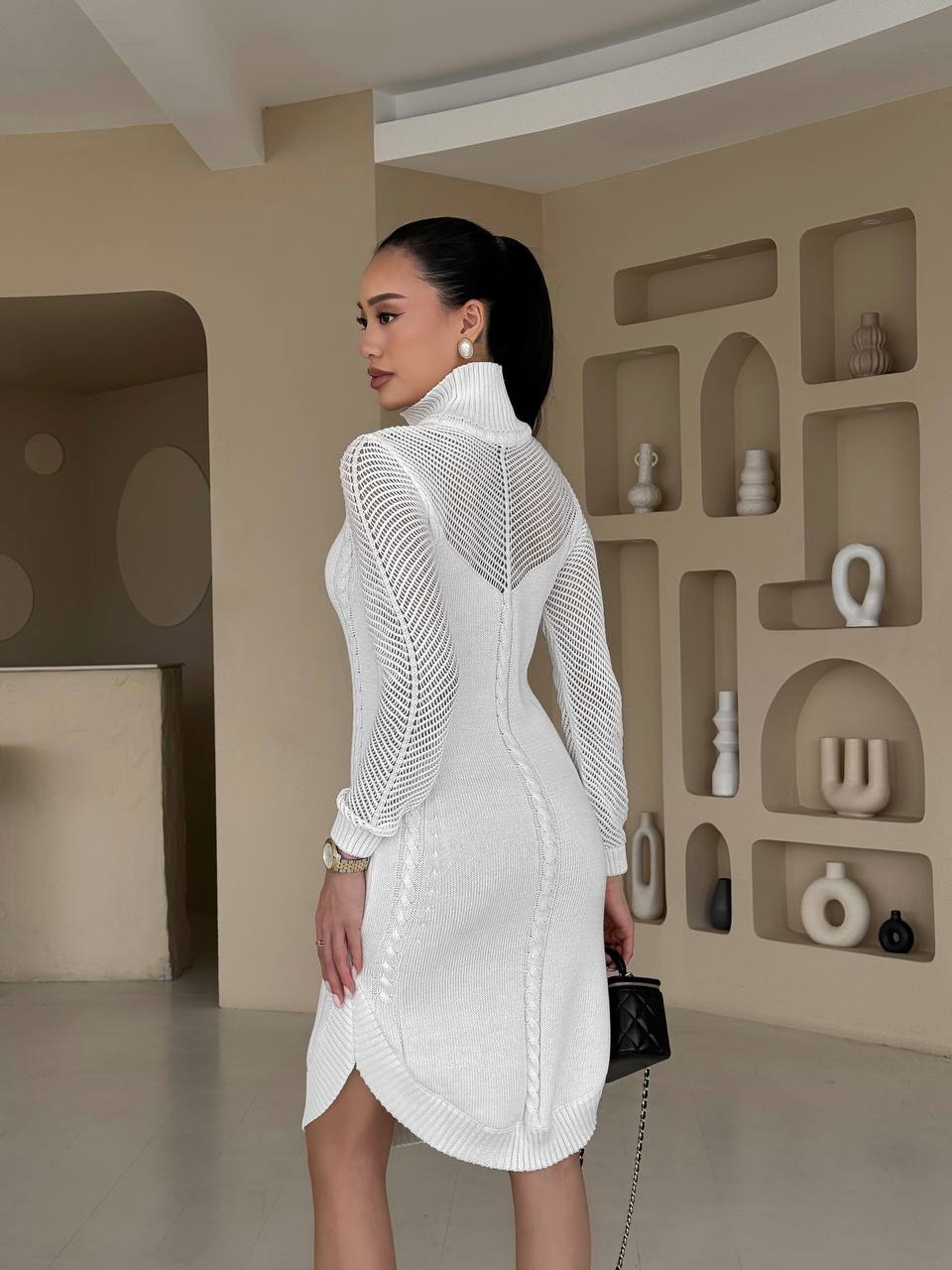 Woman wearing a white textured dress in a modern interior setting