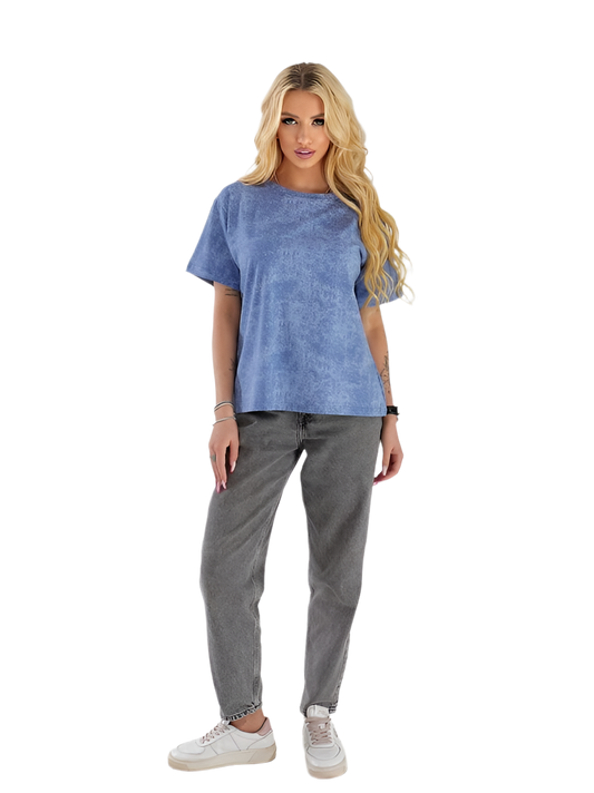 Woman wearing a blue t-shirt and gray pants on a white background