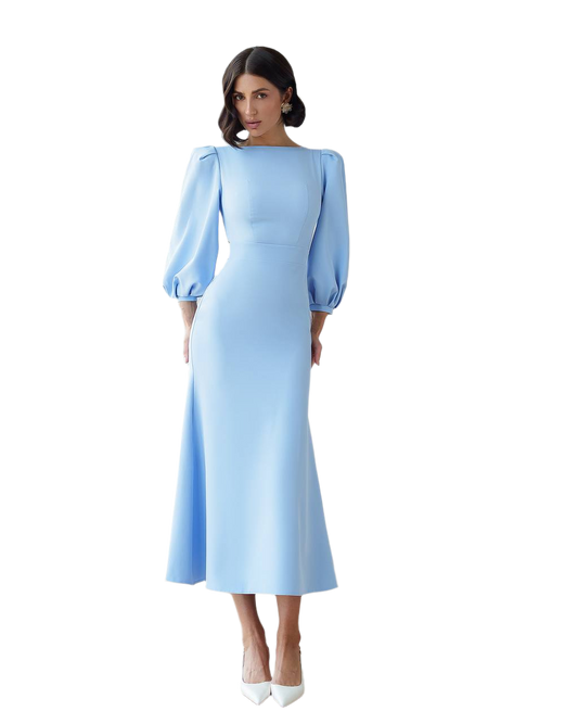 Woman wearing a light blue dress with puff sleeves on a white background