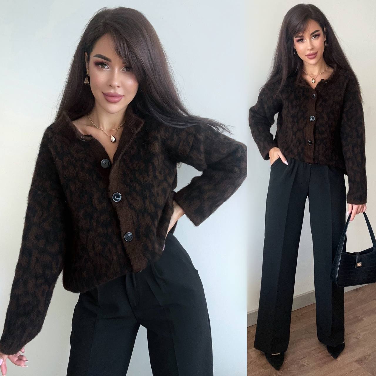 Woman wearing a brown leopard print jacket and black pants against a white wall.