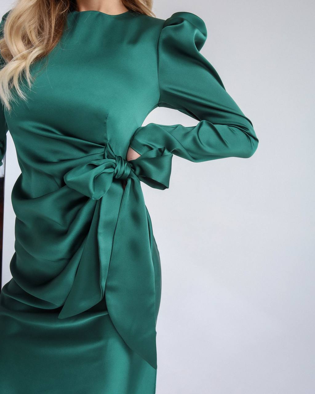 Green dress with a tie detail on a white background