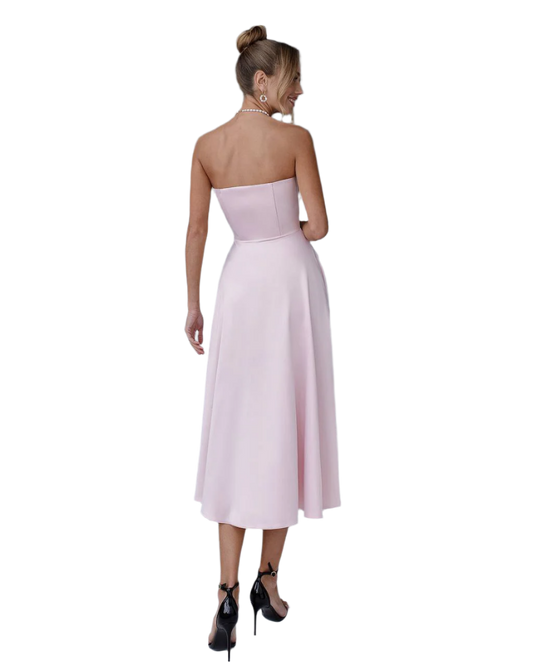 Woman wearing a strapless pink dress on a white background