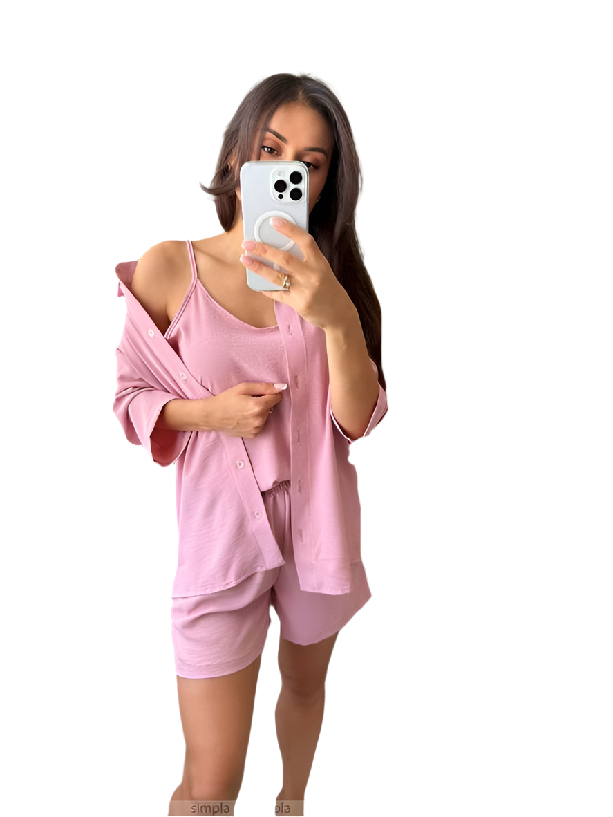 Woman taking a mirror selfie wearing a pink outfit on a white background