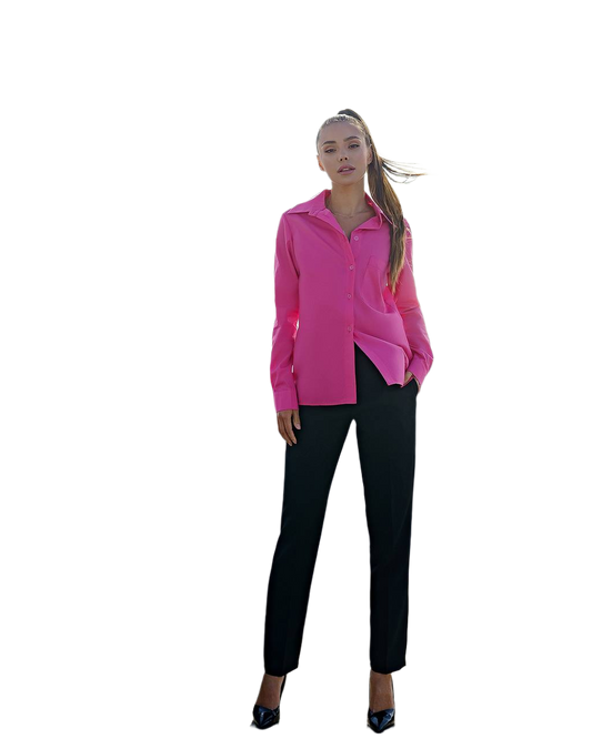 Woman wearing a bright pink blouse and black pants on a white background
