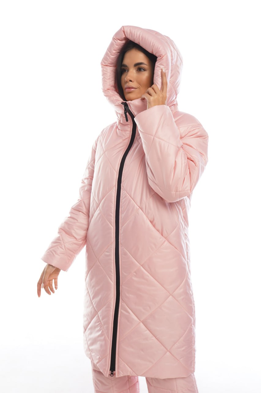 Person wearing a pink quilted jacket on a white background