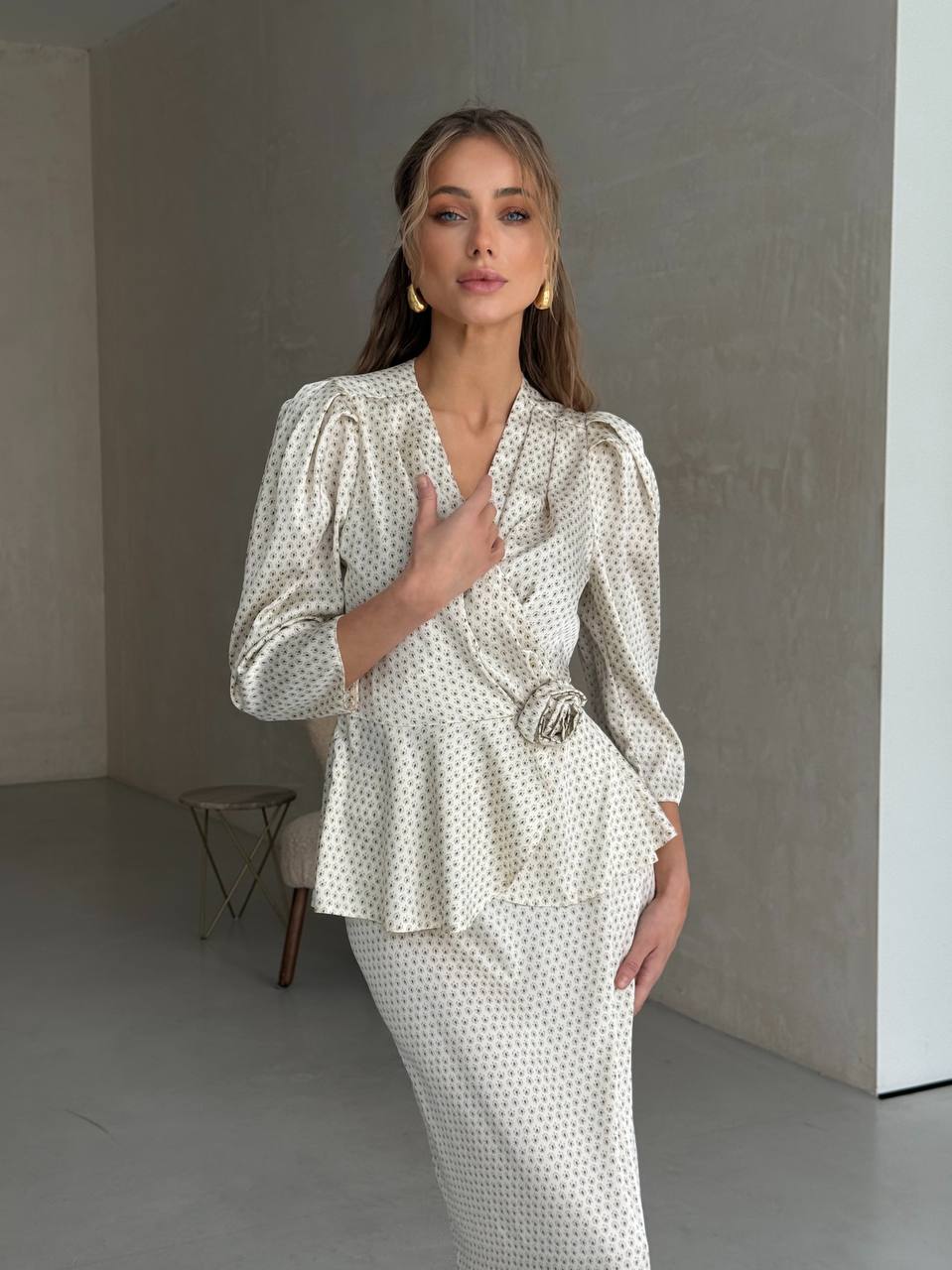 Woman wearing a patterned outfit in a minimalistic room