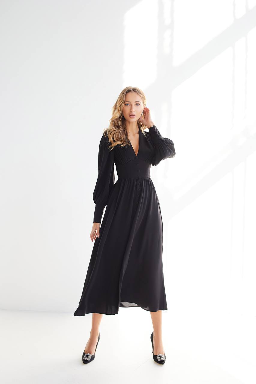 Woman wearing a black dress against a white background